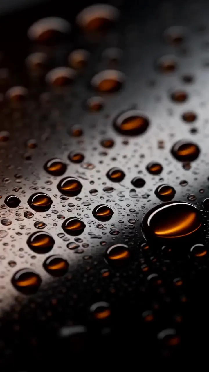A macro frame of amber droplets from the fragrance film